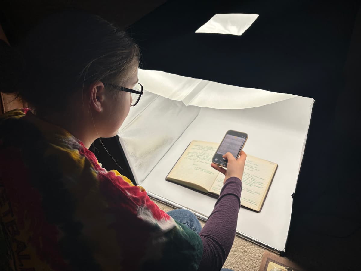 Sigita Jurgutis photographing an archival book on a light box